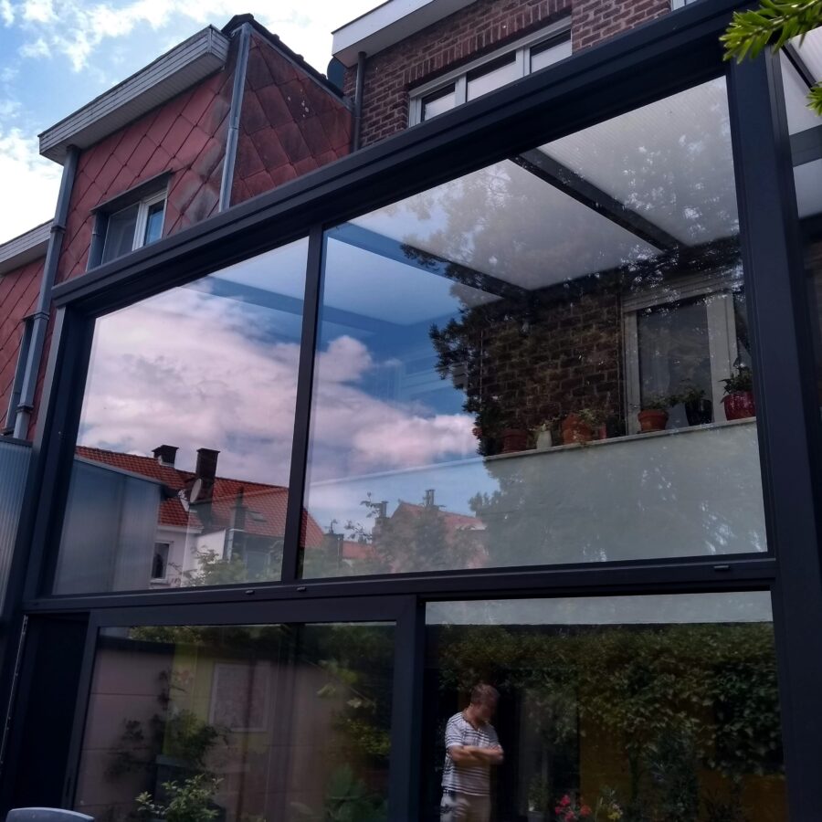 Veranda 2 verdiepingen polycarbonaat zonwerend glas schuifraam monorail Reynaers